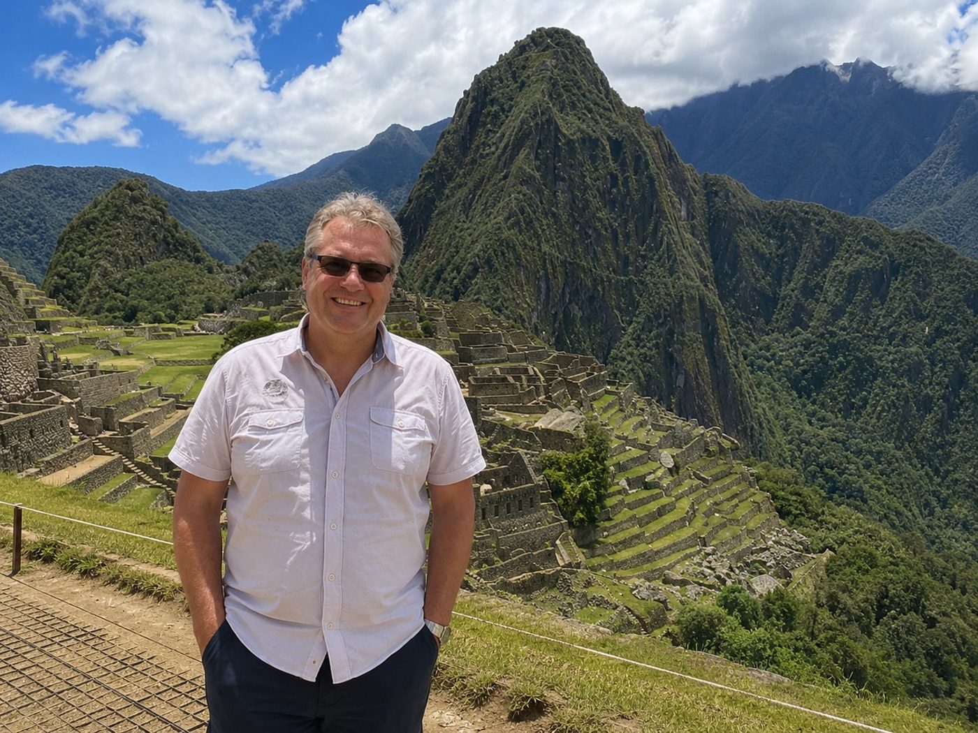 Radim Kaufmann at Machu Picchu, Peru, with the iconic Huayna Picchu peak and terraced Inca ruins behind him